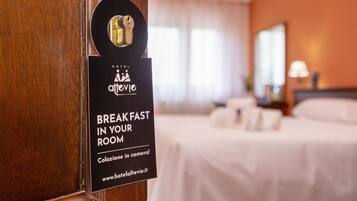 A hotel room door with a sign indicating breakfast is available in the room.