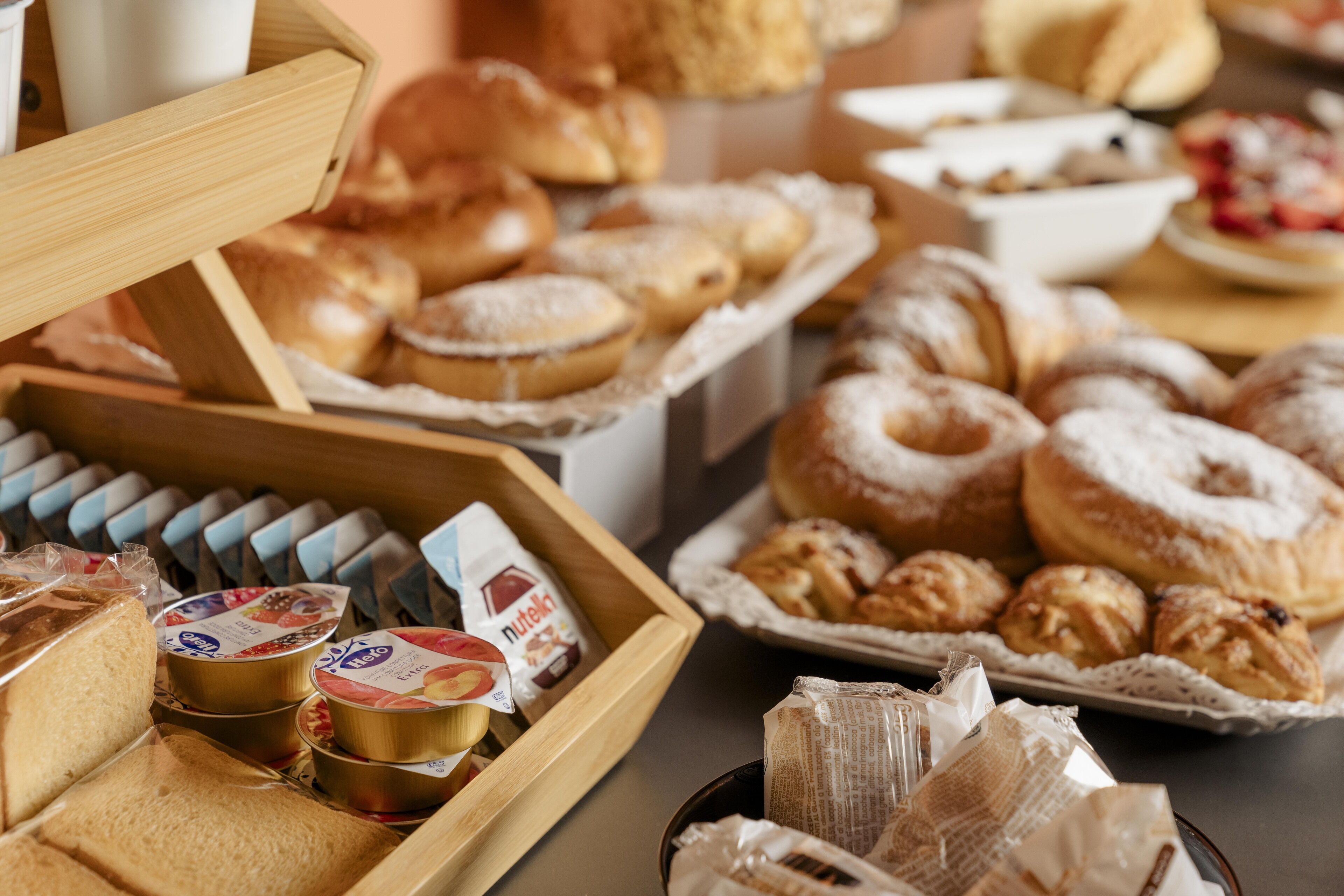 A variety of pastries and bread displayed on a table.