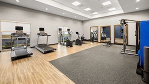 A gym with treadmills, elliptical machines, and weight equipment. - Hampton Inn & Suites Bessemer Birmingham (Bessemer)