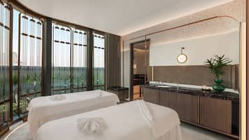 Relax in a serene space with two beds, a large window, and a contemporary bathroom.