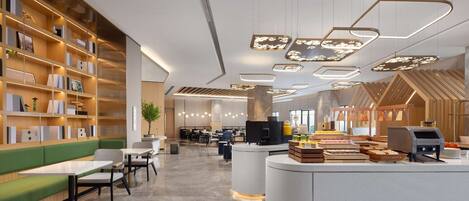 A modern library with bookshelves, seating areas, and a food service counter.