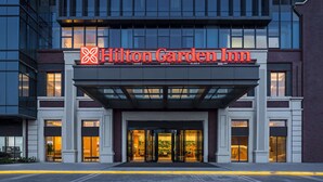 The exterior of the Hilton Garden Inn hotel with a prominent sign, large glass entrance, and a modern architectural design. - Hilton Garden Inn Zigong High-Tech Zone (Zigong)