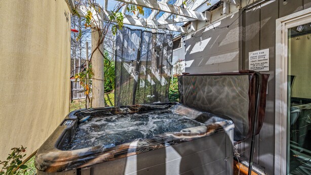 A hot tub under a pergola with a sign indicating it is for adults only. - Lumberjack Family Retreat I Putt Putt I Pool Table I Darts I Hot Tub I Firepit (Sevierville)