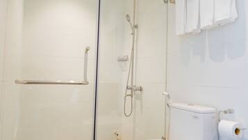 A modern bathroom with a glass-enclosed shower, a white toilet, and a towel rack.