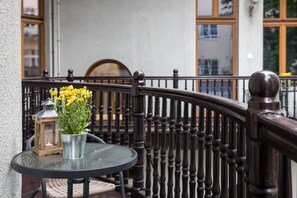 Enjoy a tranquil moment on the balcony with a potted plant and lantern.