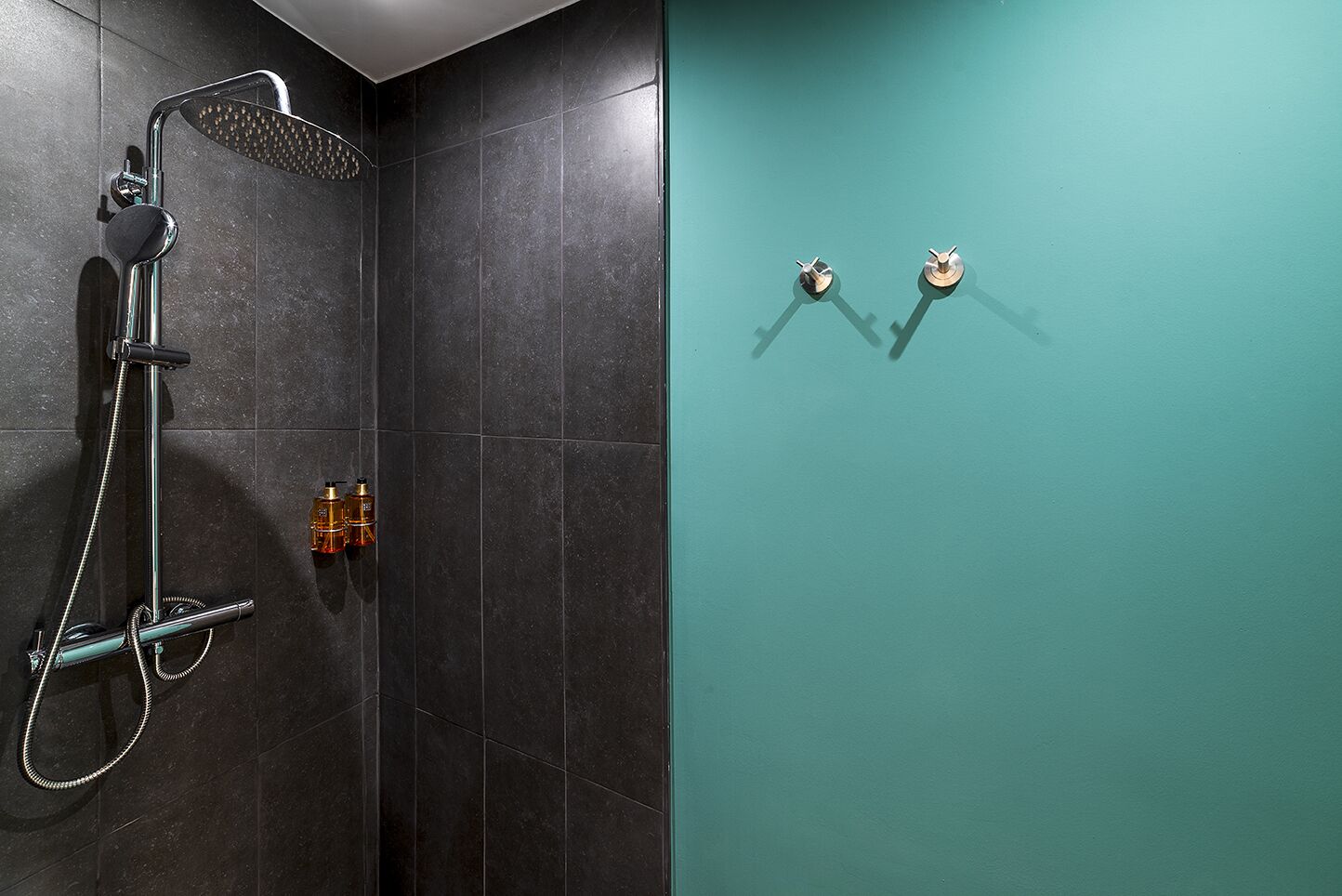 A bathroom with a shower, a toilet, and a sink.