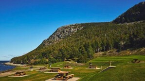 A coastal park with picnic tables and a mountain backdrop. - Cozy basement apartment suite, beautiful Paradise! (Paradise)