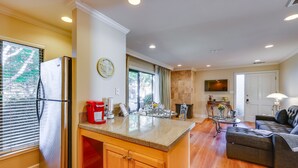 A spacious kitchen with a large island, wooden cabinets, and a built-in refrigerator. - Serene Napa Retreat w/ Pool Access & Patio! (Napa)