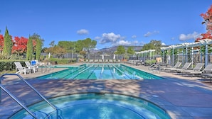 A swimming pool with multiple lanes, surrounded by lounge chairs and a pergola. - Serene Napa Retreat w/ Pool Access & Patio! (Napa)