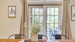 A dining table with a vase of flowers, a tray with salt and pepper shakers, and a framed botanical print on the wall. - MountainwoodMemories LkHarmony 5bedroom Pool Beach SkiResort Tennis (Lake Harmony)