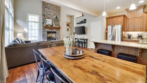 A spacious kitchen with a large wooden island, built-in appliances, and a stone accent wall. - MountainwoodMemories LkHarmony 5bedroom Pool Beach SkiResort Tennis (Lake Harmony)