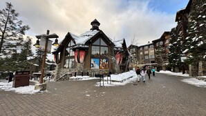 A historic building with a steeply pitched roof, large windows, and stone walls. - Premier 1 BD/1 BR condo ski in and out.  Gondola is right outside the condo. (Truckee)