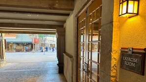 An entrance to a building with a sign for an exercise room. - Premier 1 BD/1 BR condo ski in and out.  Gondola is right outside the condo. (Truckee)