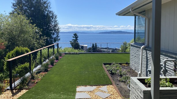 A landscaped garden with a view of the sea and mountains. - Peaceful View Home with a Cozy Modern feel walking distance to the beach (Seattle)