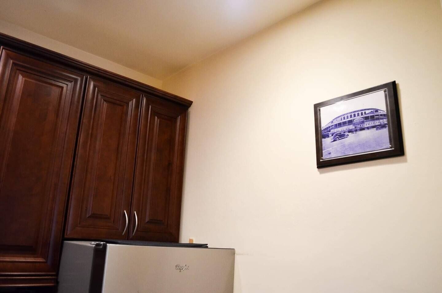 A kitchen with wooden cabinets and a refrigerator.