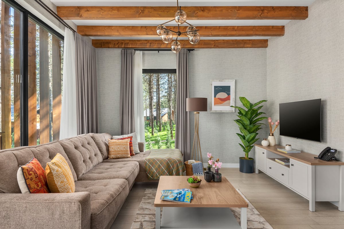 A modern living room with a sofa, coffee table, and TV.