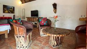 A room with a thatched roof, rustic furniture, and a tiled floor. - Complimentary 1 hr Massage in our Traditional Open-Air Palapa w/ Private Pool (Sayulita)