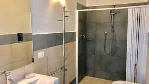 A modern bathroom with a shower, toilet, and sink. - CAMELIA by KlabHouse-2BR w/AC&Terrace-walk2beach (Sciacca)