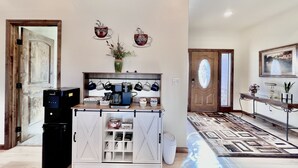 A modern kitchen with a coffee station, a trash bin, and a cabinet with storage shelves. - New home, close to skiing, hunting, rodeos, hiking. Fenced yard, pet friendly. (Darby)