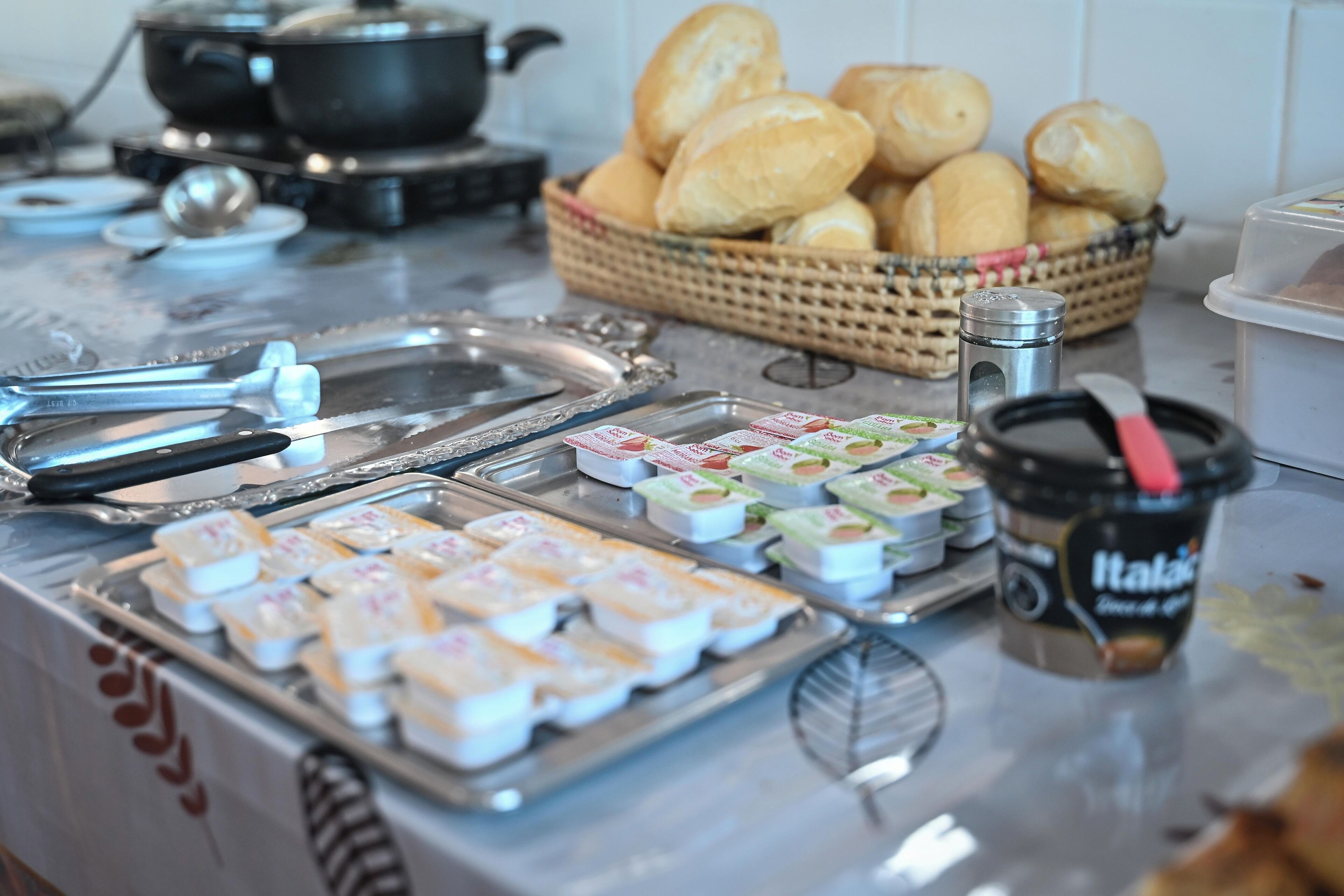 A buffet with various food items, including pastries, condiments, and beverages.