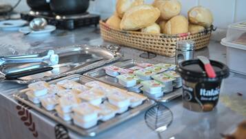 A buffet with various food items, including pastries, condiments, and beverages.
