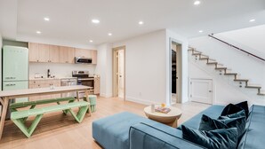 Un appartement moderne comprenant une cuisine, un coin repas et un salon.