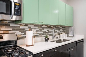 Fridge, microwave, coffee/tea maker, cookware/dishes/utensils