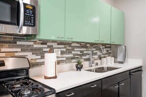 Fridge, microwave, coffee/tea maker, cookware/dishes/utensils