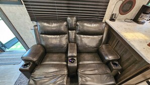 A leather recliner with cup holders and a control panel, positioned in a room with a window and blinds. - Key Lime Resorts - Unit #1 RV Retreat Villa (Monticello)
