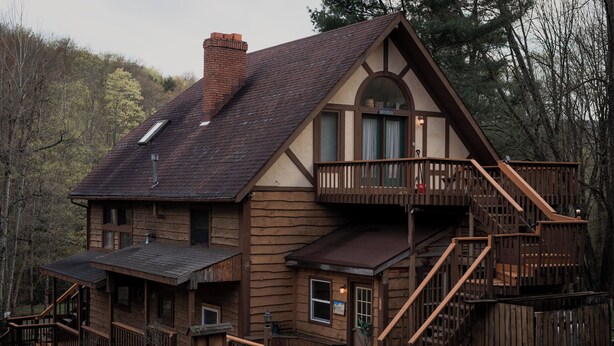 A wooden cabin with a balcony, a staircase, and a covered porch. - HUGE 3 Home Lodge For Large Groups, Lots of Space For Entertaining & Privacy! (Great Valley)