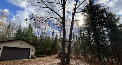 Cozi retreat set in the woods within walking distance of Waubee Lake.