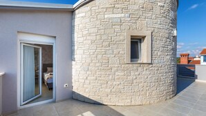 A modern building with a stone facade, a glass door entrance, and a small window. - Lovely home in Vodnjan (Vodnjan)