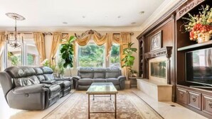 A living room with a sofa set, a coffee table, and a TV. - Vacation house with spa, pool, and water slide. (El Cajon)