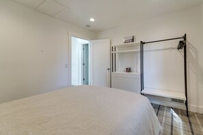 A bedroom with a bed, a wardrobe, a shelf, and a coat rack. - Steps to Beach: Family Home w/ Views in Tahoe City (Tahoe City)