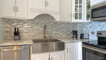 Full-sized fridge, dishwasher, cookware/dishes/utensils