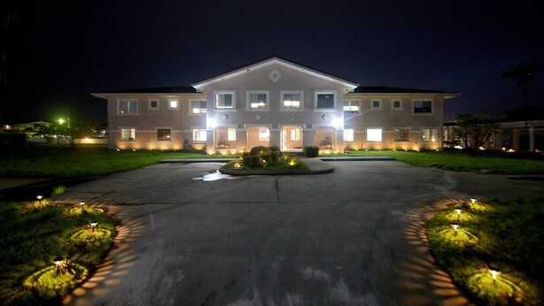 A two-story building with a symmetrical facade, multiple windows, and a central entrance. - Entire Accommodation Suites - Republic Terrace Accommodations (Republic Park, East Bank)
