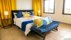A hotel room with a bed, a bench, two nightstands, and a window. - Entire Accommodation Suites - Republic Terrace Accommodations (Republic Park, East Bank)