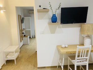 Relax in a serene space with a dining table, flat-screen TV, and comfortable seating.