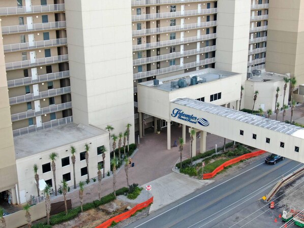 A multi-story hotel with a prominent sign for 'Tidewater Beach Resort'.