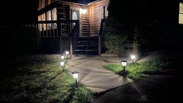 Stunning cabin-style building with a grand staircase and beautifully manicured lawn.