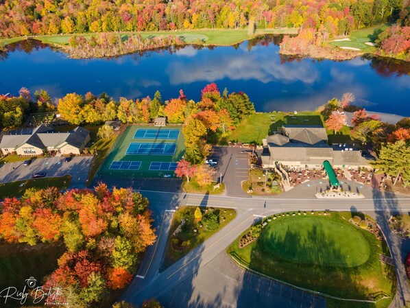 An aerial view of a golf course with a tennis court and a parking lot. - Welcome to our Pocono Cottage (Tobyhanna)