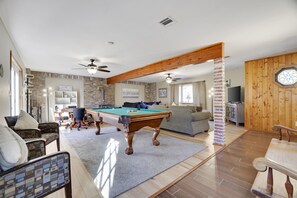 A spacious living area with a pool table, comfortable seating, and a fireplace. - Welcome to our Pocono Cottage (Tobyhanna)