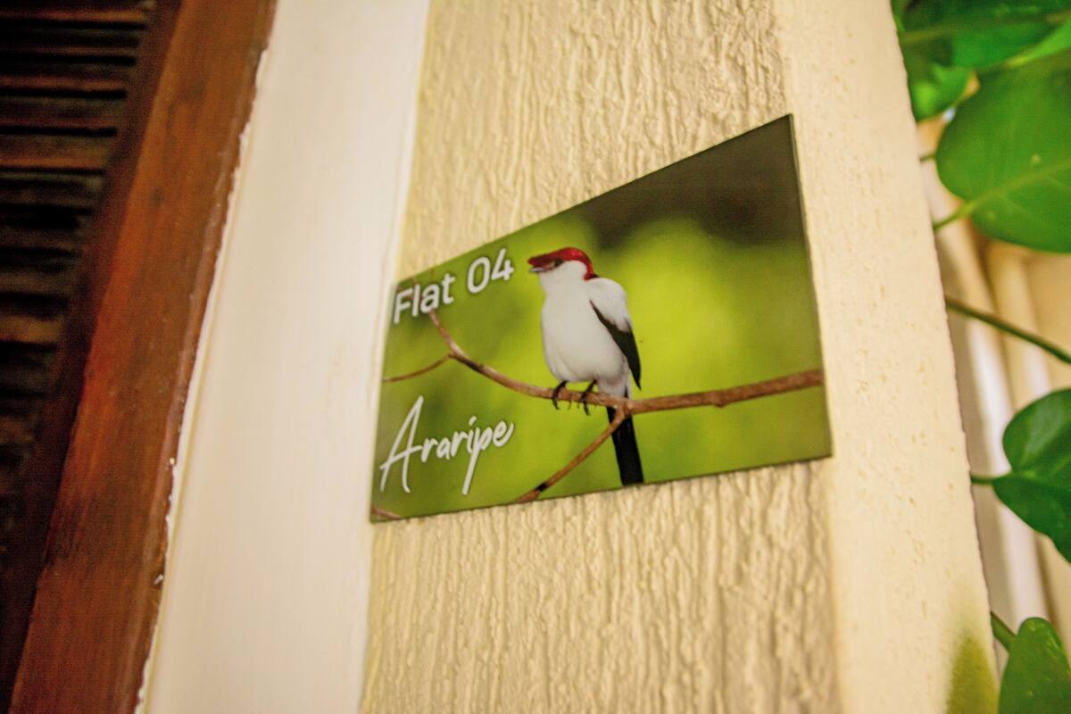 A wall-mounted sign with a bird illustration and text.
