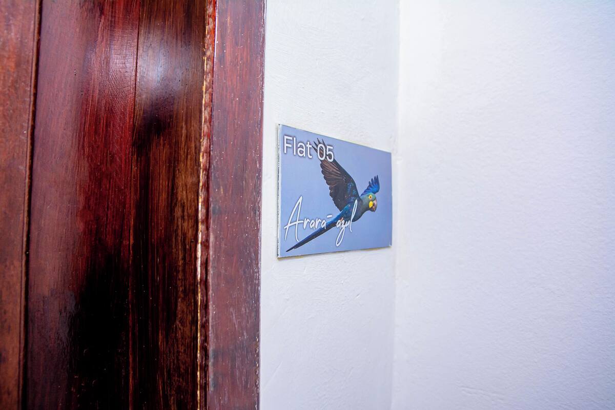 A wall-mounted sign with a bird illustration and text.