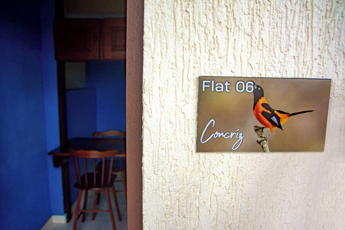 A wall-mounted sign with a bird illustration and text.