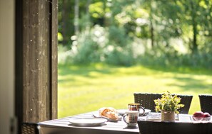 Gather around the table for a meal with a view of the serene garden.