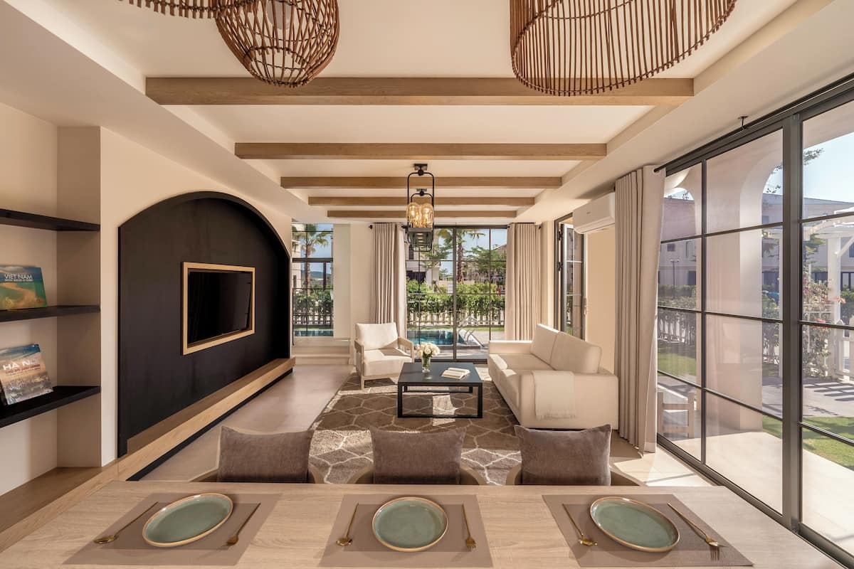 Una sala de estar moderna con un ventanal grande, una chimenea y una mesa de centro.