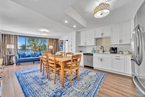 Crisp White Cabinetry and Stainless Steal Appliances Make Up This Large Kitchen.