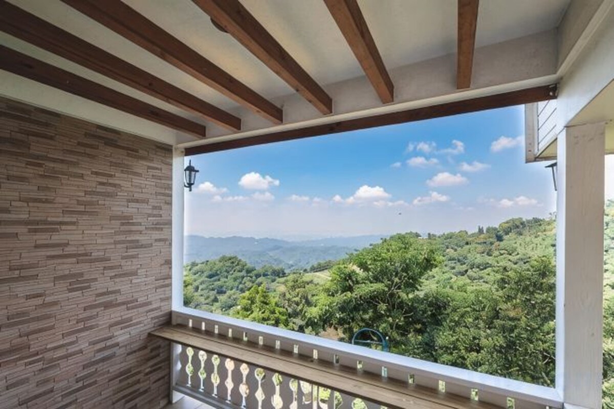 A balcony with a view of a mountainous landscape.