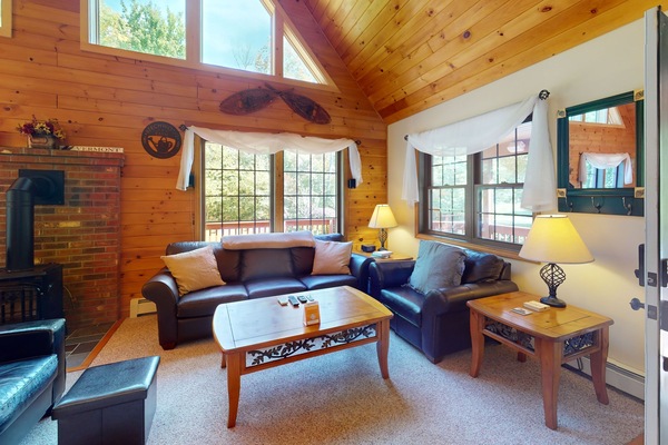 Living room with plenty of seating and natural lighting.